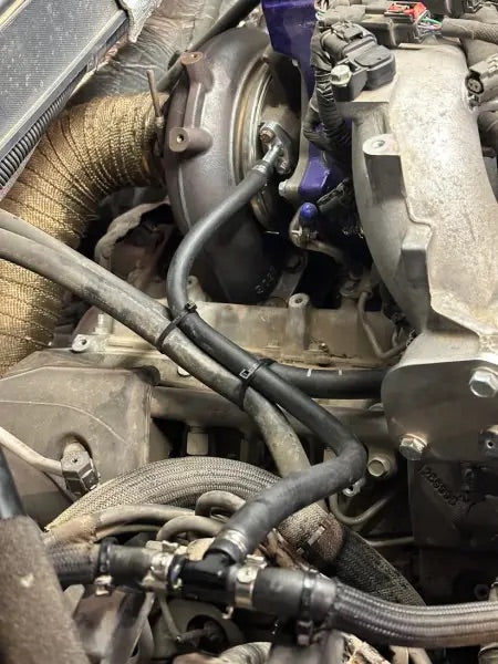 Close-up of a car engine with visible components and wiring.